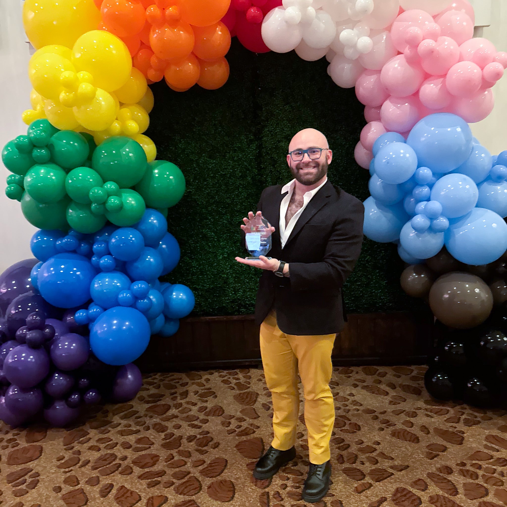 Steven Romeo holds the LGBTQ+ Business of the Year Award